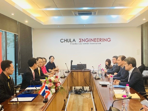 Some people attending meeting, the writing on the wall says 'Chula Engineering'