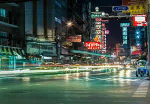 View of City Buildings and Street with Lights at Night Time
