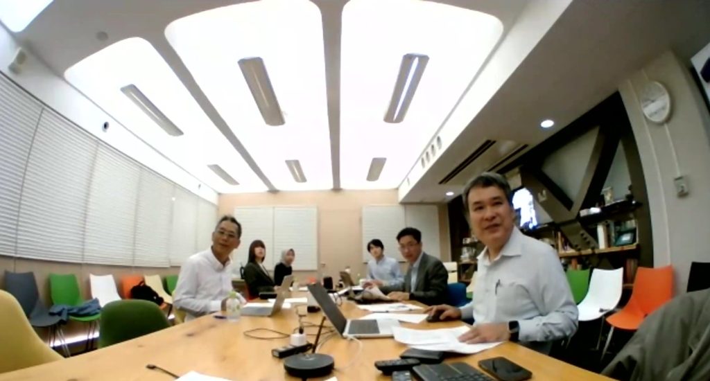 Some people attending a hybrid meeting
