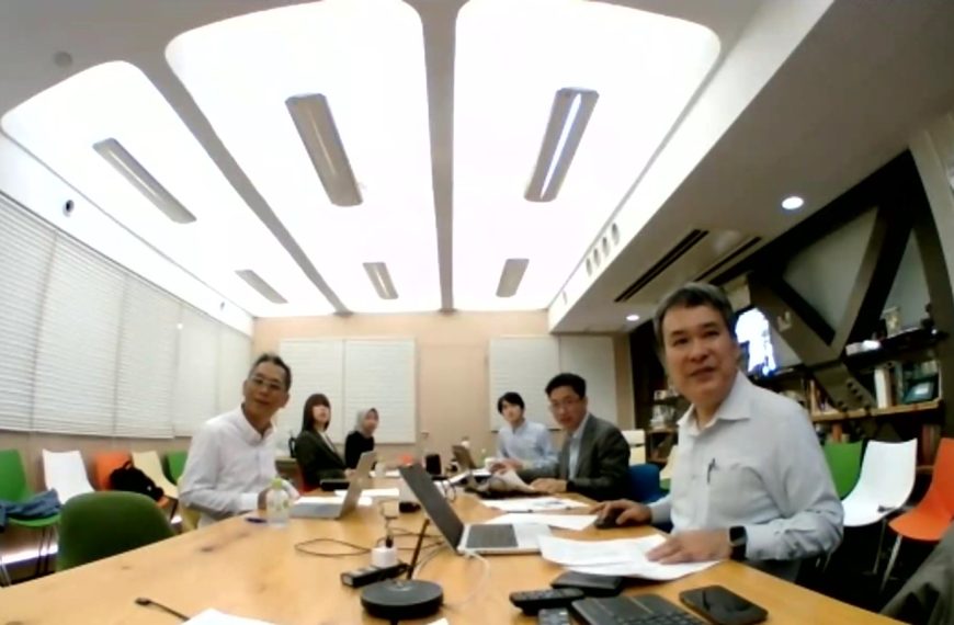 Some people attending a hybrid meeting